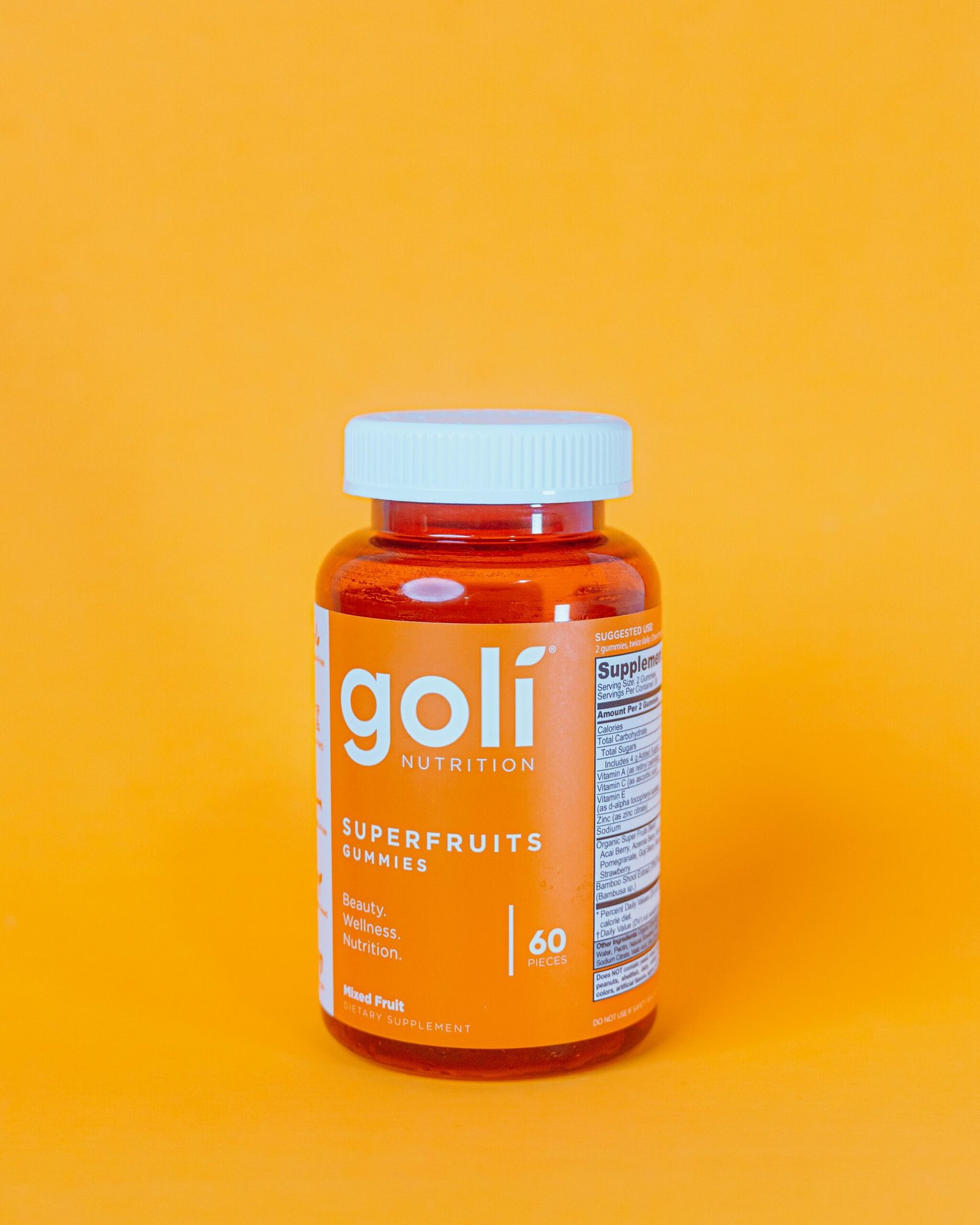 a bottle of golf nutrition superfruits on a yellow background